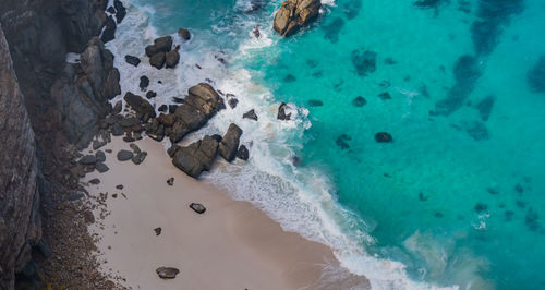 Steep cliffs and turquoise sea at the cape of good hope in south africa