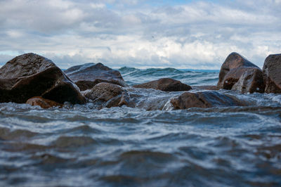 Rocks on beach against sky