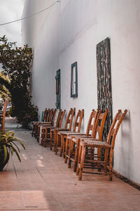 Empty chairs and tables against wall in building