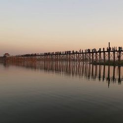 Pier on sea at sunset