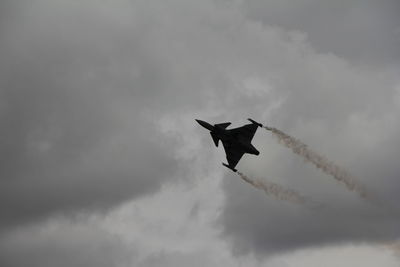 Low angle view of airplane flying against sky