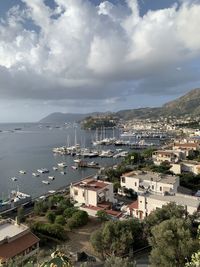 High angle view of townscape by sea against sky