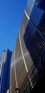 Low angle view of modern building against clear blue sky