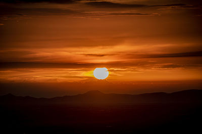Scenic view of silhouette mountain against romantic sky at sunset
