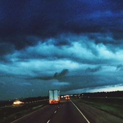 Road leading towards dramatic sky