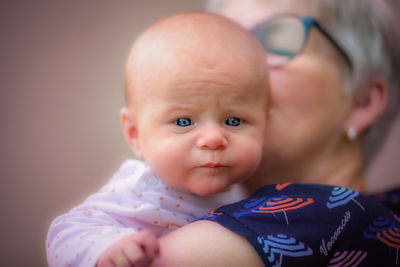 Portrait of cute baby girl with woman