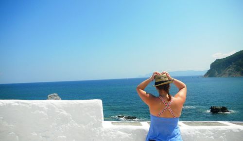 Rear view of woman in front of sea