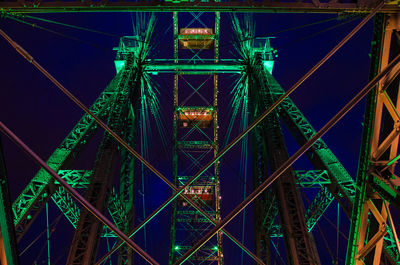 Low angle view of illuminated bridge against blue sky