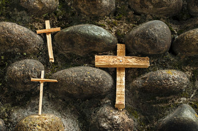 Wooden crosses on a stone wall