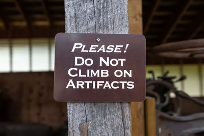 Close-up of information sign on tree trunk