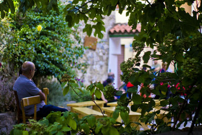 Man sitting by building