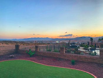 Scenic view of park against sky during sunset