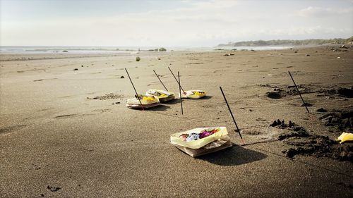 Abandoned boat on beach against sky