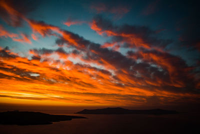 Scenic view of dramatic sky over sea during sunset