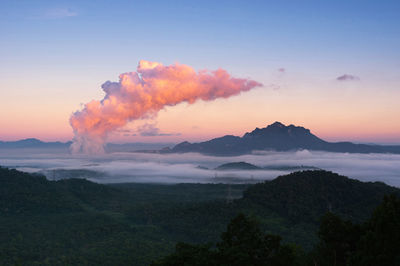 Sea of fog in the forest, high voltage pole and steam from the coal power plant. mae moh, lampang, 
