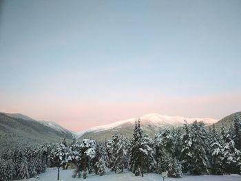 Scenic view of snow covered mountains against sky