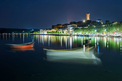 Nightview of the ancient village of marta, on the shore of bolsena lake in lazio, italy