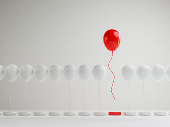 Close-up of red balloons against white background