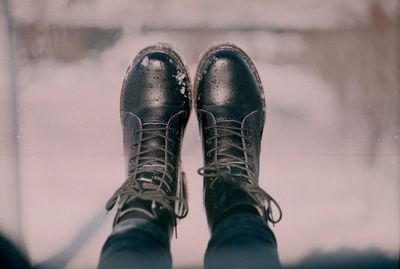 Low section of man wearing shoes