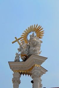 Low angle view of statue against clear blue sky