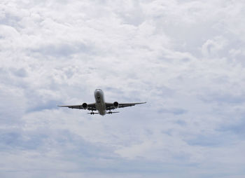 Low angle view of airplane flying in sky