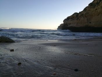 Scenic view of beach against clear sky