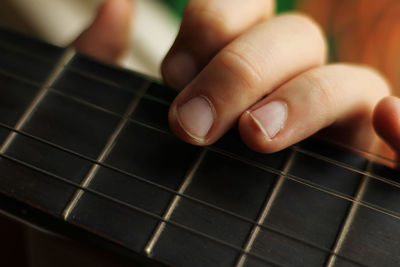 Close-up of hands playing guitar