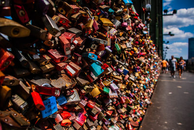 Padlocks on railing of bridge in city