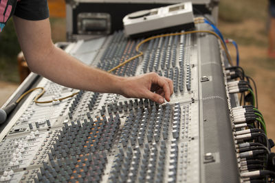 Close-up of hand using sound mixer