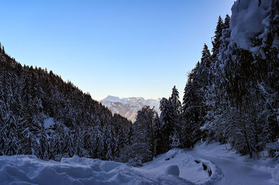 Scenic view of snow covered mountains against clear sky