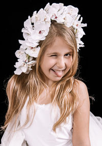 Portrait of a smiling girl against black background