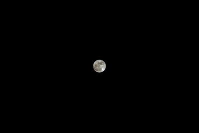 Low angle view of full moon against clear sky at night