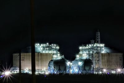 Illuminated street lights against clear sky at night