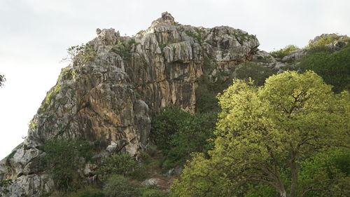 Low angle view of rock formations against sky