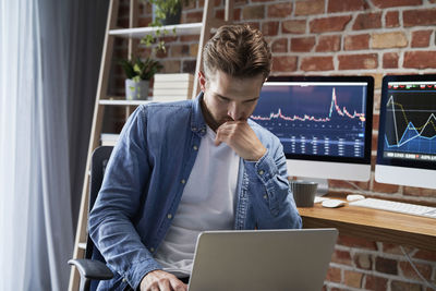 Young man using laptop at office