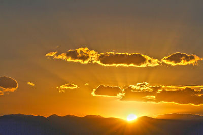 Scenic view of silhouette mountains against sky during sunset