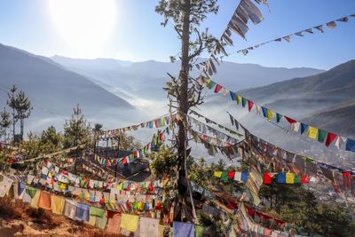 Panoramic view of multi colored flags hanging against sky