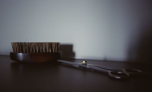 Close-up of cake on table against wall