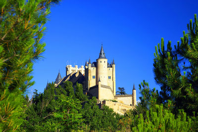 Low angle view of building against clear blue sky