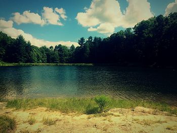 Scenic view of lake against cloudy sky