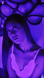 Portrait of a beautiful young woman holding purple