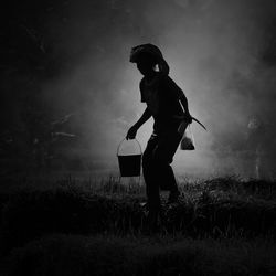 Full length of woman standing on field against sky