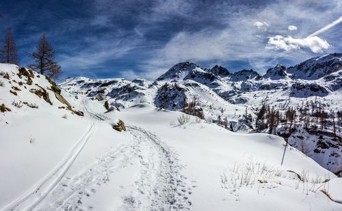 Scenic view of snow covered mountains against sky