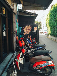 Motor scooter on street amidst buildings in city