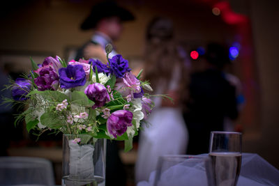 Close-up of purple flower vase on table