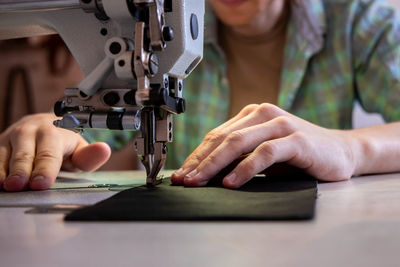 Close-up of woman working at machine