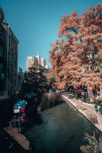 Canal amidst buildings against sky in city