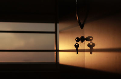 Close-up of key on locker against window