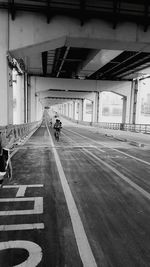 People riding bicycle on road in city