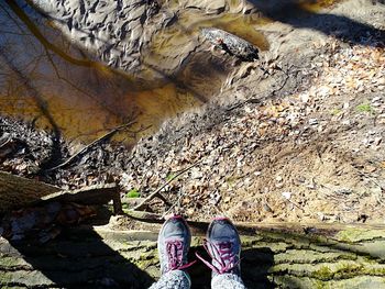 Low section of woman standing on rocks